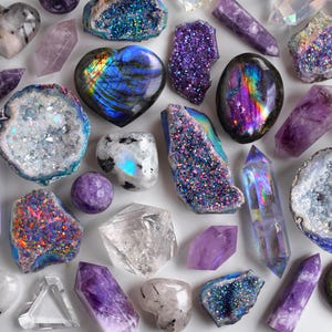 May include: An assortment of colorful crystals and gemstones, including amethyst, quartz, and labradorite. The crystals are in various shapes and sizes, with a range of colors from purple to iridescent. Some are heart-shaped or geode-like.