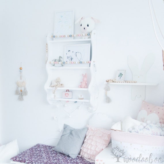 white floating shelves nursery