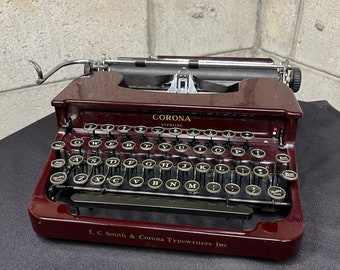 1930’s L.C. Smith Corona Sterling typewriter and case maroon