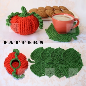 May include: Crochet pumpkin mug cozy and leaf-shaped coasters. The pumpkin cozy is orange and has a green stem. The coasters are green and have a leaf shape. The word "PATTERN" is written in black letters on a white background.