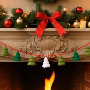 May include: A decorated Christmas mantelpiece with a garland of crocheted Christmas trees in green and white, strung on a red cord. The mantelpiece also features candles, baubles, and a red bow.