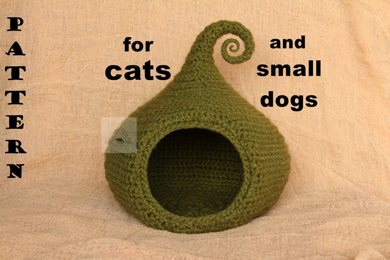 May include: A green crocheted cat or small dog bed with a curled top. The text "PATTERN" is on the left side of the image and the text "for cats and small dogs" is on the right side of the image.