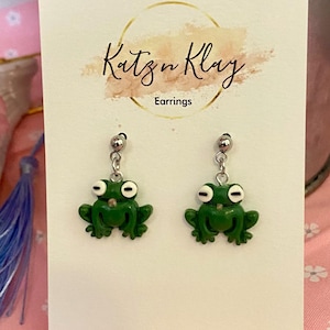 May include: A set of three ceramic mugs with a speckled, matte finish. The mugs are in shades of cream, light gray, and dark gray. Each mug has a simple, minimalist design, perfect for coffee or tea.