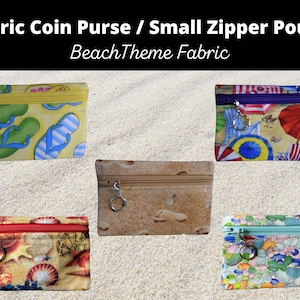 May include: Five small zipper pouches with beach-themed fabric designs. The pouches are yellow with flip flops, brown with sand, blue with seashells, green with pebbles, and purple with beach umbrellas.