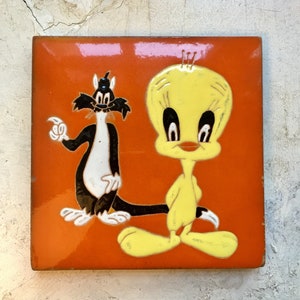 Vintage enameled orange trivet decorated with Tweety and Sylvester, enameled ceramic handmade in France in the 1960's RefA7