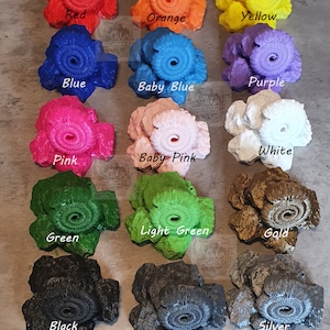 May include: A collection of 12 ammonite-shaped resin rocks in various colors, including red, orange, yellow, blue, baby blue, purple, pink, baby pink, white, green, light green, gold, black, grey, and silver.