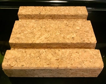 Pair of Cork trivets. You will receive (2) trivets of a similar shape and size (5x6 inches) with channels routed for mobile devices.