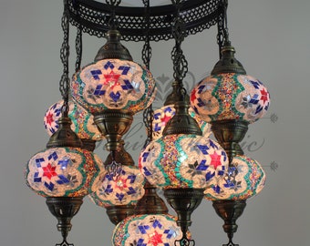 May include: A multi-tiered chandelier with eight round, mosaic glass globes. The globes are decorated with a variety of colors, including blue, green, red, and white. The chandelier is made of metal and has a black finish.