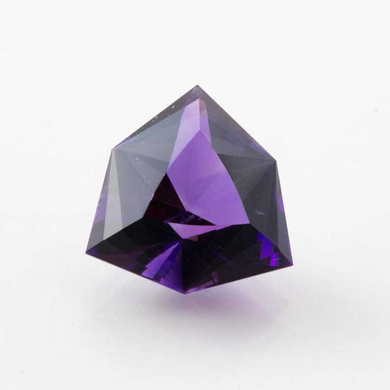 faceted in America. 7.40 carat Amethyst trilliant gemstone from Uruguay