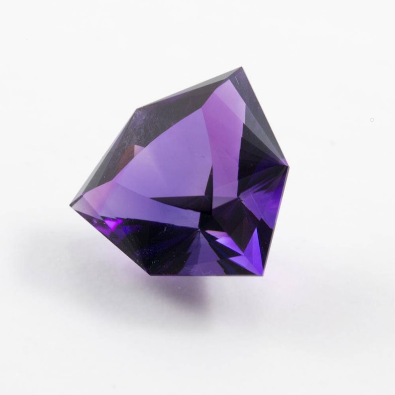 faceted in America. 7.40 carat Amethyst trilliant gemstone from Uruguay