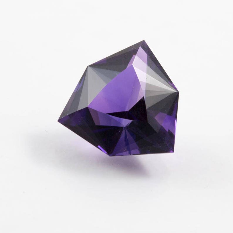 faceted in America. 7.40 carat Amethyst trilliant gemstone from Uruguay