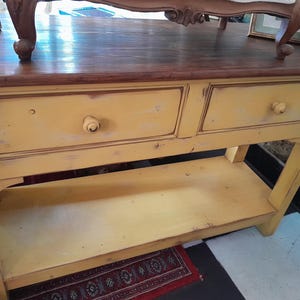 gorgeous yellow antiqued console table with solid wood top.