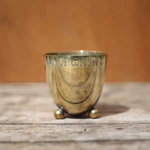 Silver-plated metal goblet with alphabet motifs on ball feet, silver-plated metal cup signed LR, collection
