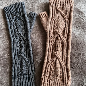 May include: Two pairs of fingerless gloves, one gray and one brown, with a cable knit pattern.