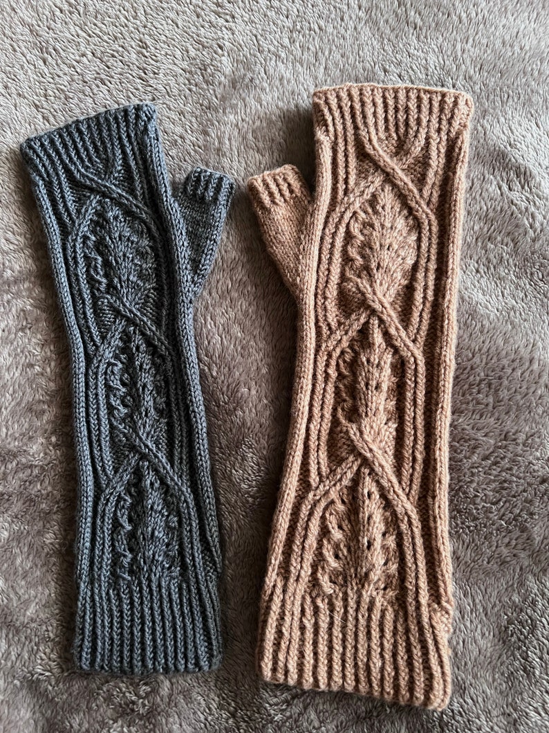 May include: Two pairs of fingerless gloves, one gray and one brown, with a cable knit pattern.