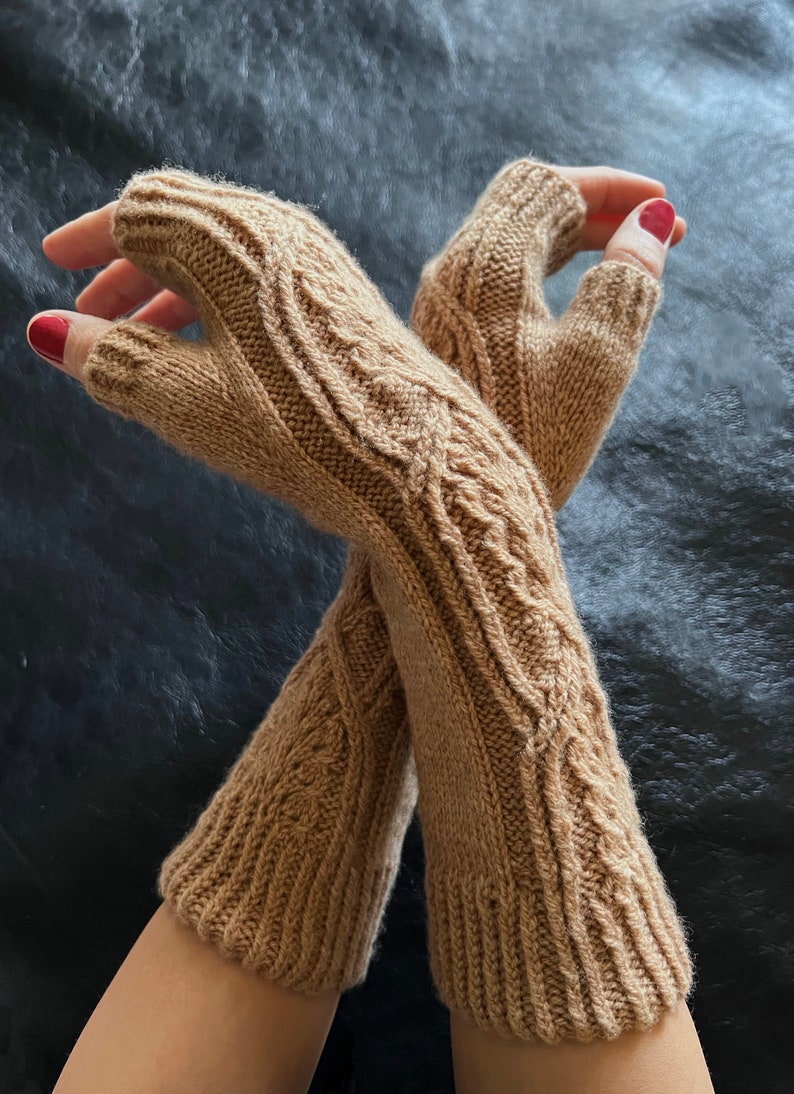 May include: A pair of brown fingerless gloves with a cable knit pattern. The gloves are made of a soft, warm material and are perfect for keeping your hands warm in the winter.