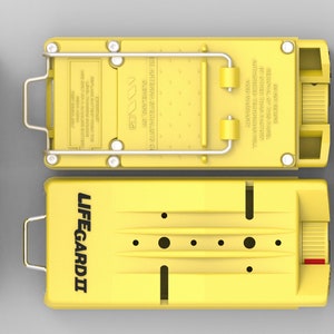 May include: Yellow Lifeguard II safety device with a black label and a black switch. The device has a metal handle and a black knob. The device is on a gray background.