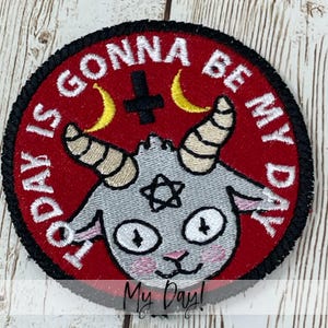 May include: Embroidered patch with a red background and black border. The patch features a gray goat with a pentagram, a cross, and crescent moons. The text "TODAY IS GONNA BE MY DAY" is embroidered around the edge.