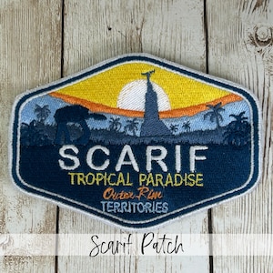 May include: Embroidered patch with a tropical landscape design. The patch features a yellow sun, palm trees, and the text "SCARIF TROPICAL PARADISE Outer Rim TERRITORIES". The patch is blue, yellow, and orange.
