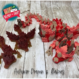 May include: A collection of autumn-themed dragon figurines in shades of red, brown, and tan. The dragon figures are intricately designed with leaf-like details and a textured appearance. The text "Autumn Dragon & Babies" is visible.