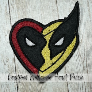 May include: A heart-shaped patch featuring a split design of Deadpool and Wolverine. The Deadpool side is red and black, while the Wolverine side is yellow and black. The patch has embroidered details and the text "Deadpool Wolverine Heart Patch".