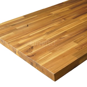 May include: Close-up of a rectangular wooden countertop. The countertop is constructed from multiple planks of light brown wood, arranged in a staggered pattern. The wood grain is visible, and the edges are smooth and finished.