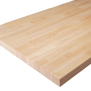 May include: A rectangular butcher block countertop made of light-colored wood. The wood grain is visible, and the surface is smooth. The countertop is likely for a kitchen or workspace.