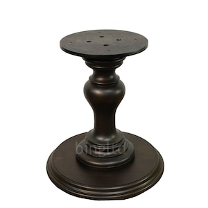 May include: Dark brown wooden table base with a round top and a pedestal base. The base has a smooth, polished finish.