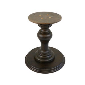 May include: A dark brown wooden table base with a round top and a pedestal base. The base has a fluted design and a smooth finish.