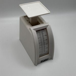 May include: A white Polder kitchen scale with a square platform and a curved front. The scale has a measurement indicator for ounces and grams. The scale can measure up to 1000 grams or 35 ounces.