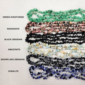 May include: Six strands of chip gemstone beads in various colors, including green aventurine, rhodonite, black obsidian, amazonite, snowflake obsidian, and sodalite.