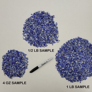 May include: Three piles of blue and silver lapis lazuli chips on a white surface. The piles are labeled "4 OZ SAMPLE", "1/2 LB SAMPLE", and "1 LB SAMPLE".