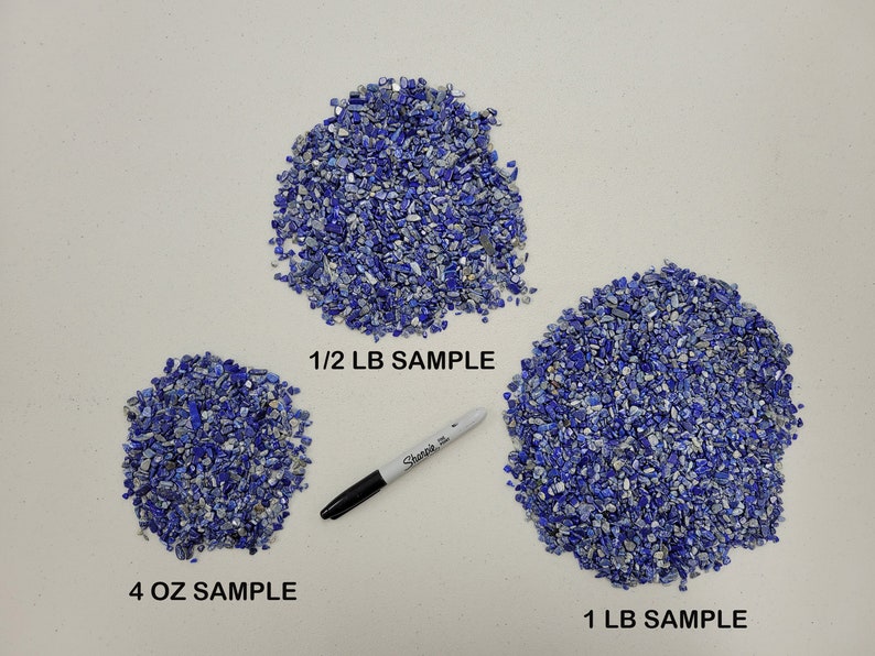May include: Three piles of blue and silver lapis lazuli chips on a white surface. The piles are labeled "4 OZ SAMPLE", "1/2 LB SAMPLE", and "1 LB SAMPLE".