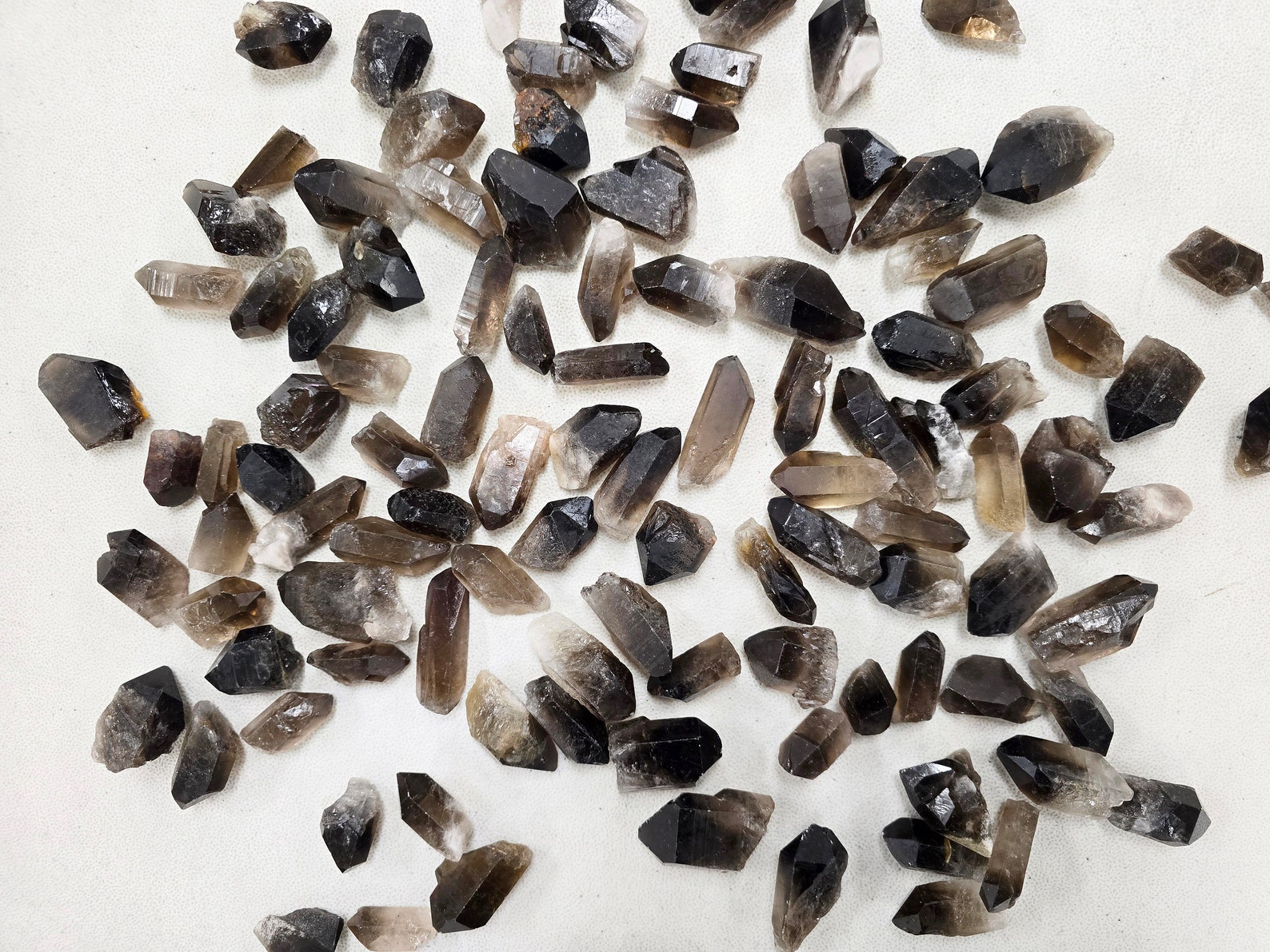 Raw smoky quartz crystals used to balance Sagittarius energy by promoting calm, focus, and emotional grounding.