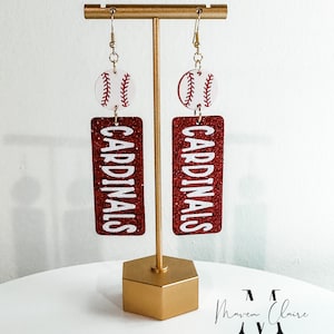 May include: Red glitter earrings with a white baseball charm and the word "CARDINALS" in white lettering.