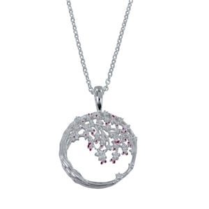 May include: A silver necklace with a round pendant featuring a detailed tree design with pink accents.
