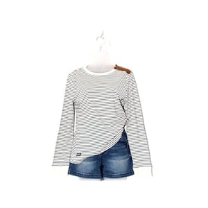 May include: A long-sleeved, striped shirt with a brown leather shoulder patch and denim shorts. The shirt features black and white horizontal stripes and white cuffs. The denim shorts are a dark blue wash.