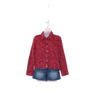 May include: A red floral print button-down shirt with long sleeves and a collar, paired with denim shorts. The shirt has a pattern of small, colorful flowers. The outfit is displayed on a white mannequin.