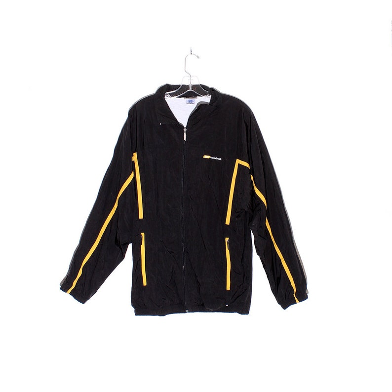 vintage 80s 90s windbreaker Reebok jacket black with pin stripes down sleeve and front oversized windbreaker track jacket 90s clothing