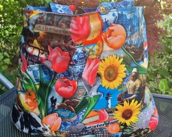 Może przedstawiać: Kolorowa torba typu tote z motywem holenderskim. Torba zawiera obrazy tulipanów, wiatraków i kanału Amsterdamskiego. Torba jest wykonana z wytrzymałego materiału i ma dużą pojemność.