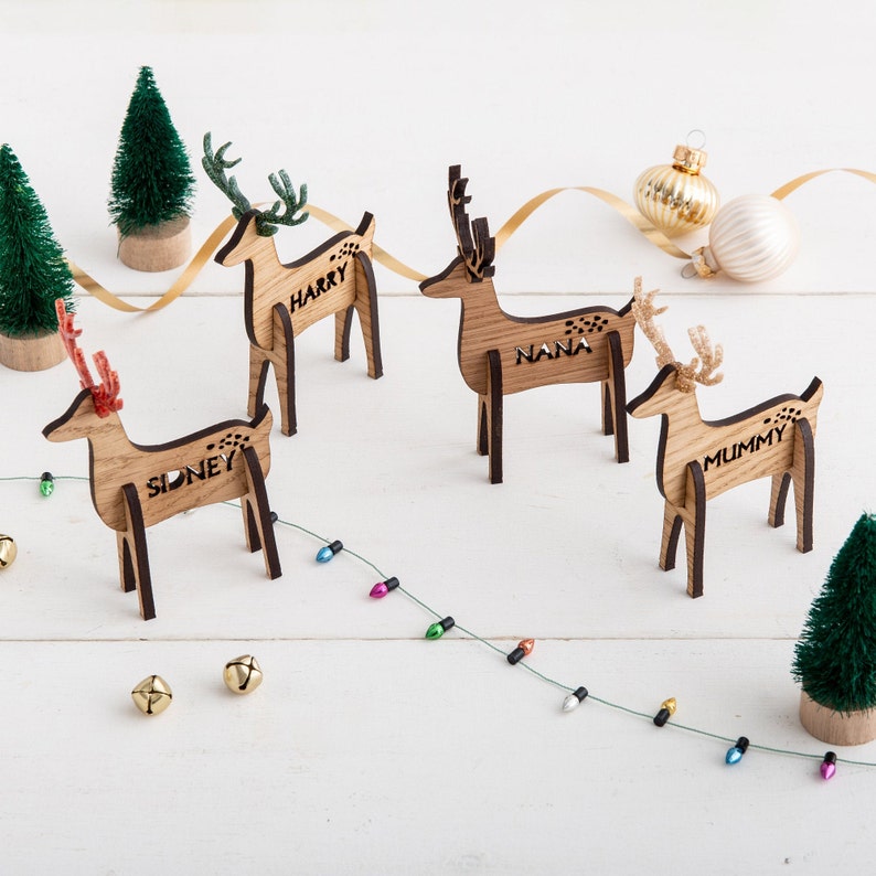 Wooden freestanding reindeer shaped Christmas place setting, personalised with your guests name and finished with glitter antlers. Christmas table decorations for 2023