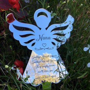 May include: A silver mirrored angel with the word "Nana" engraved on the front. The angel has a heart and a quote that reads "Goodbyes are not forever, Goodbyes are not the end, They simply mean we'll miss you until we meet again."