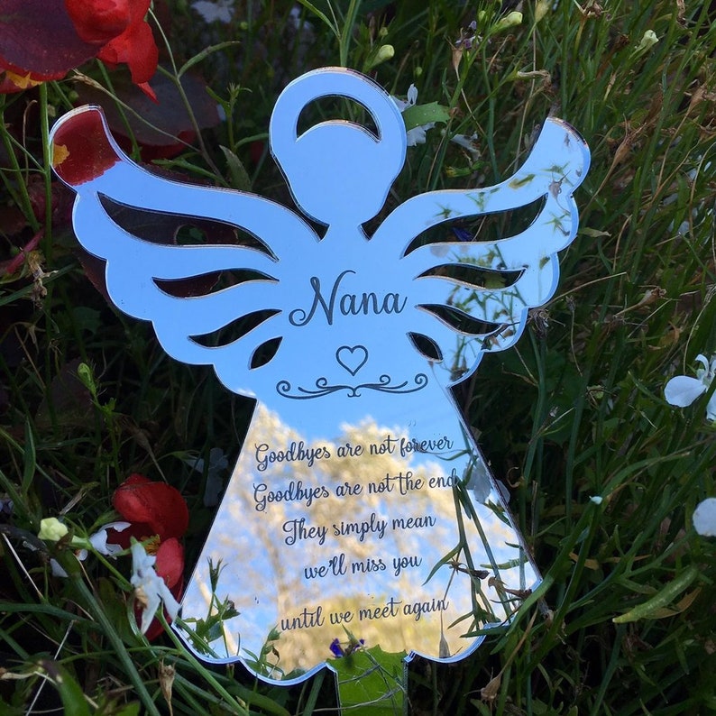 May include: A silver mirrored angel with the word "Nana" engraved on the front. The angel has a heart and a quote that reads "Goodbyes are not forever, Goodbyes are not the end, They simply mean we'll miss you until we meet again."
