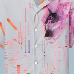 May include: White button-up short-sleeve shirt with a vibrant graphic design. The design features a pink and purple illustration and colorful vertical lines. The shirt has the text "OKAMI.EXE BY KACIX" on the collar.