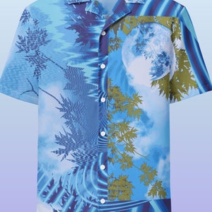 May include: Short-sleeved button-down shirt with a blue and white landscape design. The shirt features a full moon, trees, and a wavy pattern. The shirt has a classic collar and white buttons.