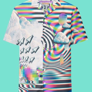 May include: A white button-up shirt with a colourful, psychedelic pattern. The pattern features a repeating design of rainbow stripes, clouds, and pixelated arrows. The shirt has a collar and short sleeves. The text "The Computing Elite" is printed on the front of the shirt.