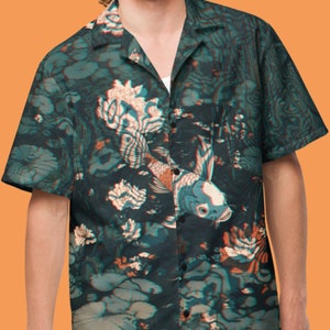 May include: A short-sleeved button-up shirt with a dark green, blue, and orange floral print featuring koi fish.