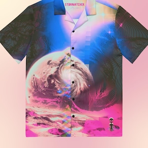 May include: A short-sleeved button-up shirt with a colorful, abstract design featuring a planet, a swirling vortex, and a small alien figure. The shirt has a collar and a button closure. The text "Stormwatcher" is printed on the collar.