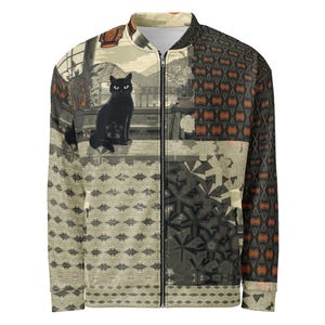 May include: A zip-up bomber jacket with a unique patchwork design. The jacket features a black cat illustration on a beige background with a Japanese-inspired landscape. The right side has a geometric pattern in shades of brown and gray.
