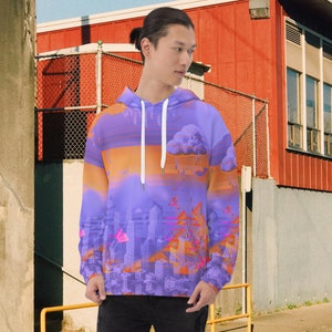 May include: A hooded sweatshirt with a vibrant cityscape design. The hoodie features a purple and orange color scheme with a cloud and skyscraper graphic. The drawstring is white.